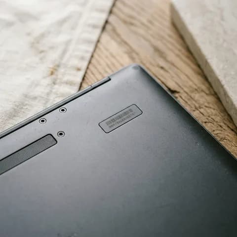 The serial number under the lid. A smartphone, tablet, smartwatch, headphones and earbuds case on a pale blue background.